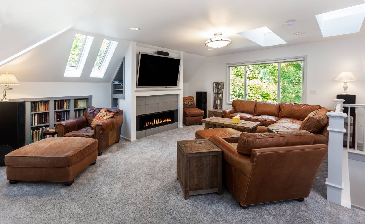 Skylights without Hunter Douglas Roman shades in a cozy media room with large leather couches at Wessco Blinds near Seattle, WA