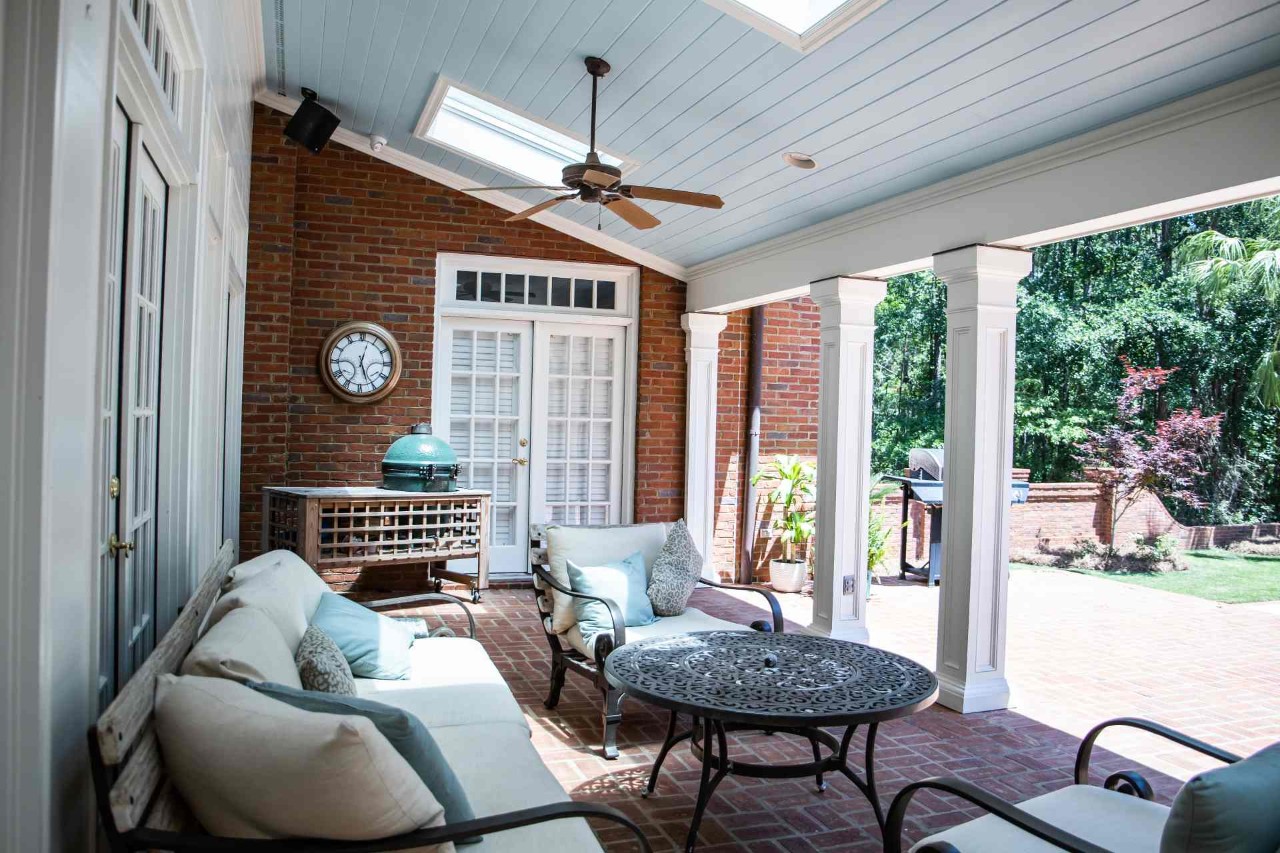 A well-decorated outdoor patio with blue accents and sunshades on the patio's French doors leading inside near Seattle, Washington (WA)