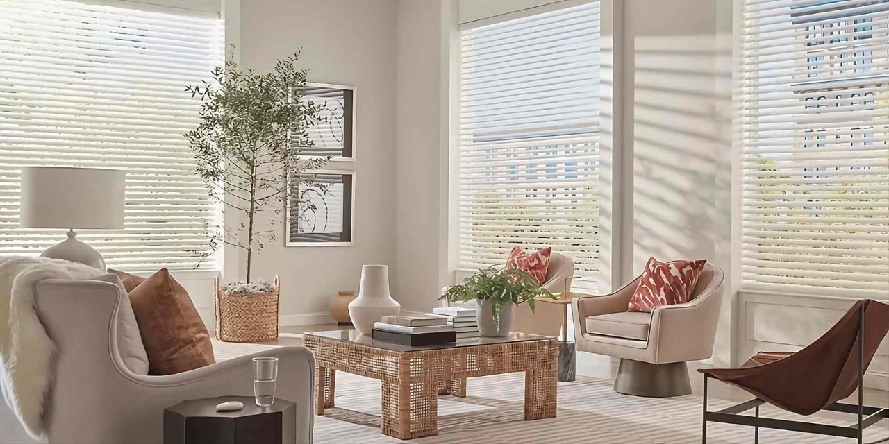 Stunning Hunter Douglas Aria™ Fabric Blinds on large windows in a modern, airy, neutral living room at Wessco Blinds near Seattle, WA